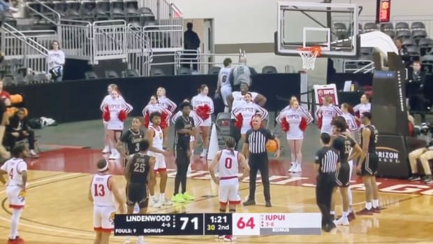 A fan in a LeBron James Heat jersey is escorted out of a Lindenwood vs. IUPUI game after trying to check in.
